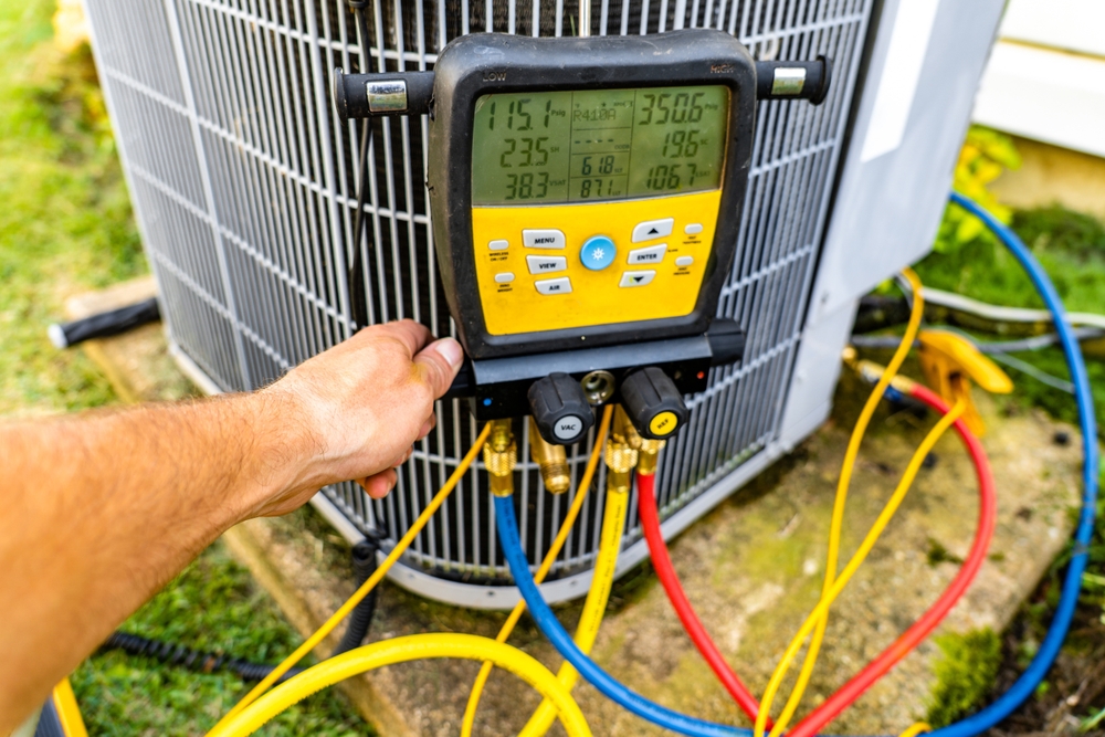 AC repair being performed on an outdoor unit