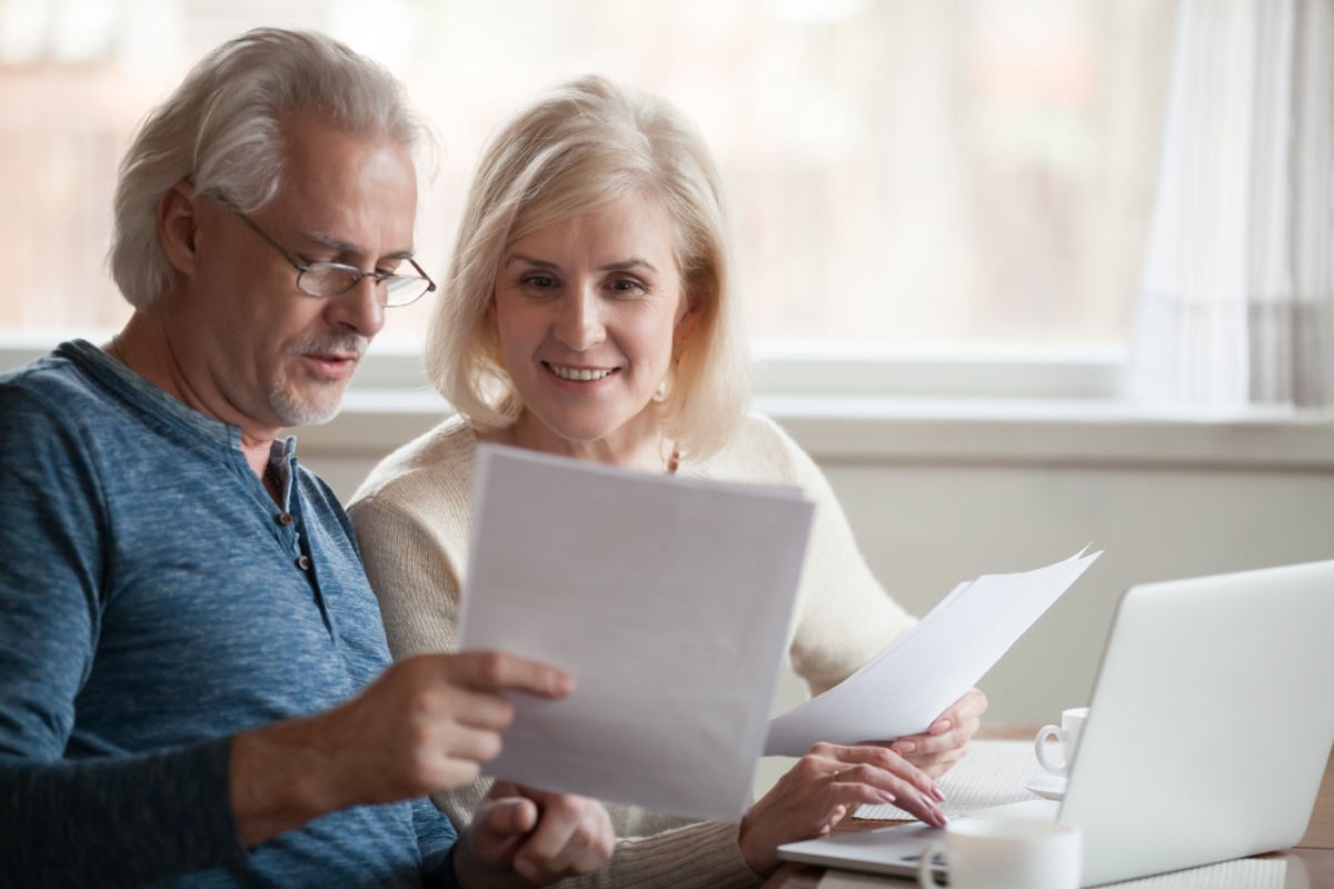 An elderly couple comparing heating costs