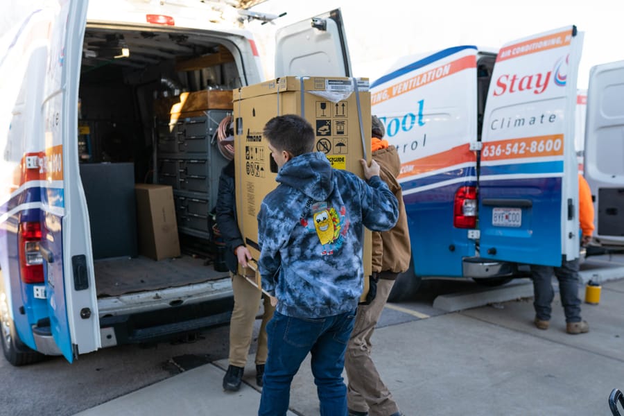 carrying new unit for emergency HVAC services