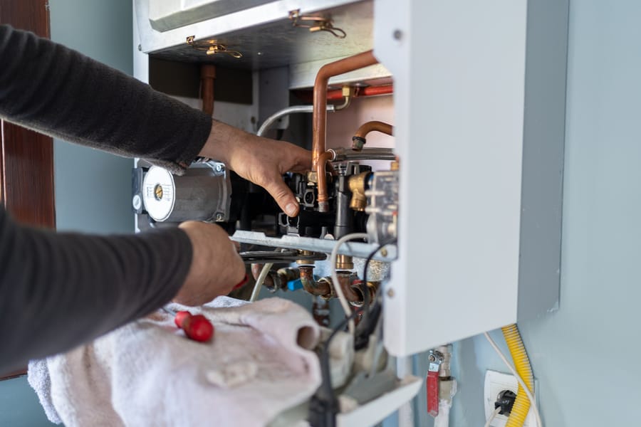 furnace being repaired during a furnace service