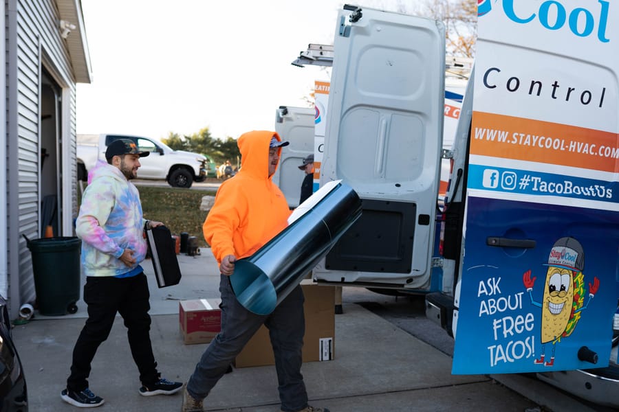 HVAC employees unloading materials for a heating installation