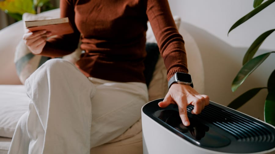 woman turning on a UV Air Sanitizer